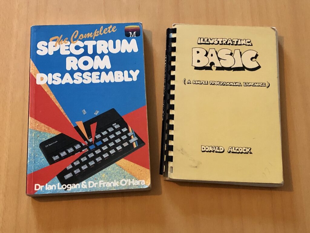 Two old computing books: "The Complete Spectrum ROM Disassembly" by Dr. Ian Logan and Dr. Frank O'Hara, and "Illustrating BASIC (A Simple Programming Language)" by Donald Alcock.