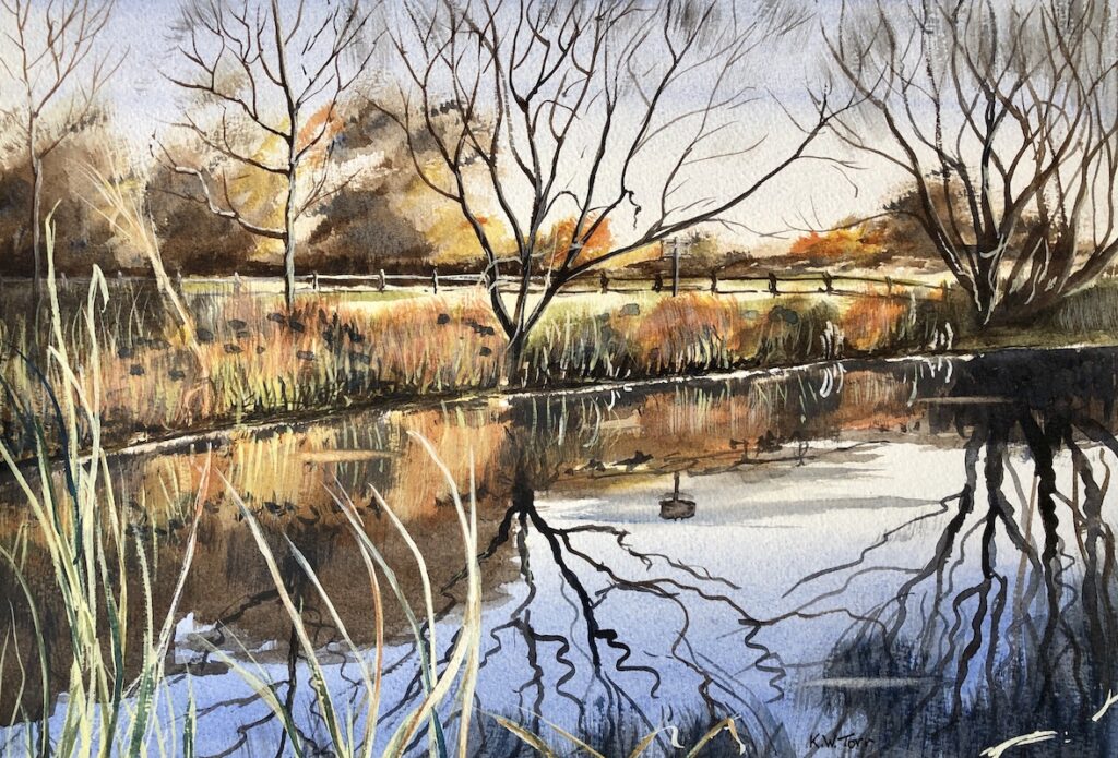Watercolour of a river with bare trees and Autumnal colours, and reflections in a river.